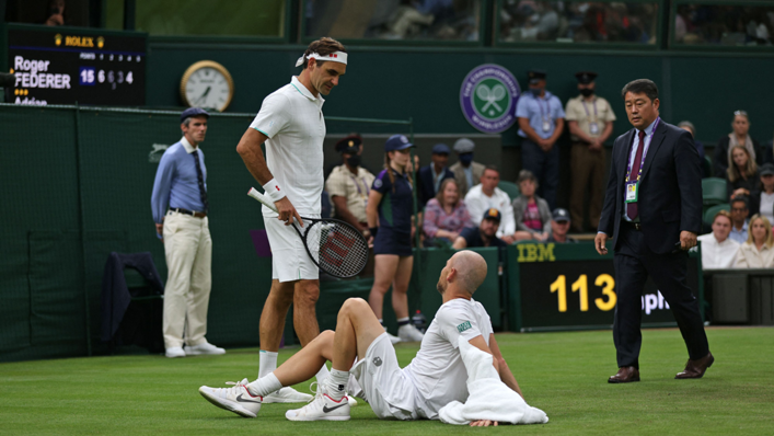 Roger Federer consoles an injured Adrian Mannarino