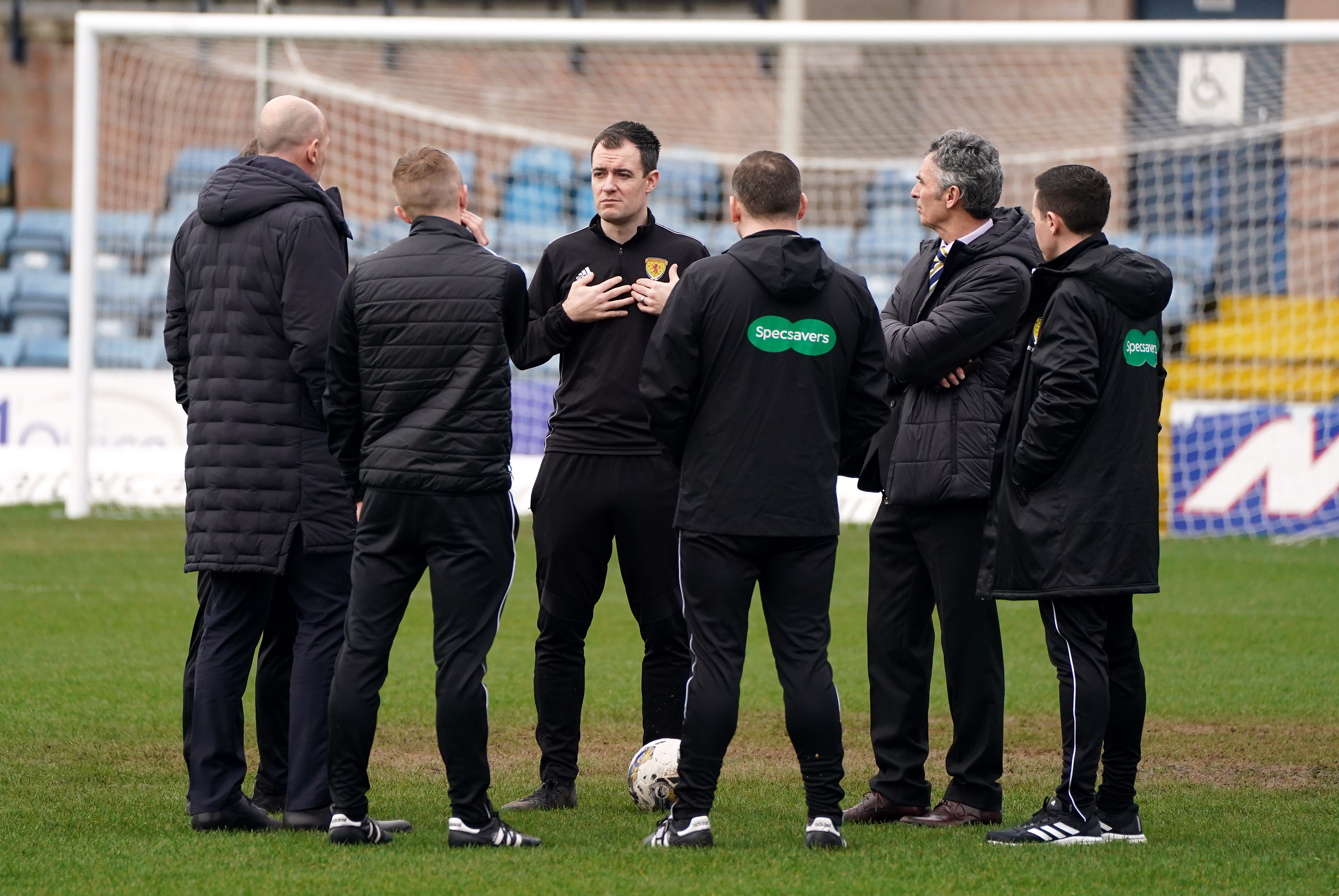 Referee Don Robertson speaks to officials and Rangers manager Philippe Clement before postponing the cinch Premiership match