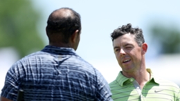 Tiger Woods (l) praised Rory McIlroy after an impressive start to his tournament