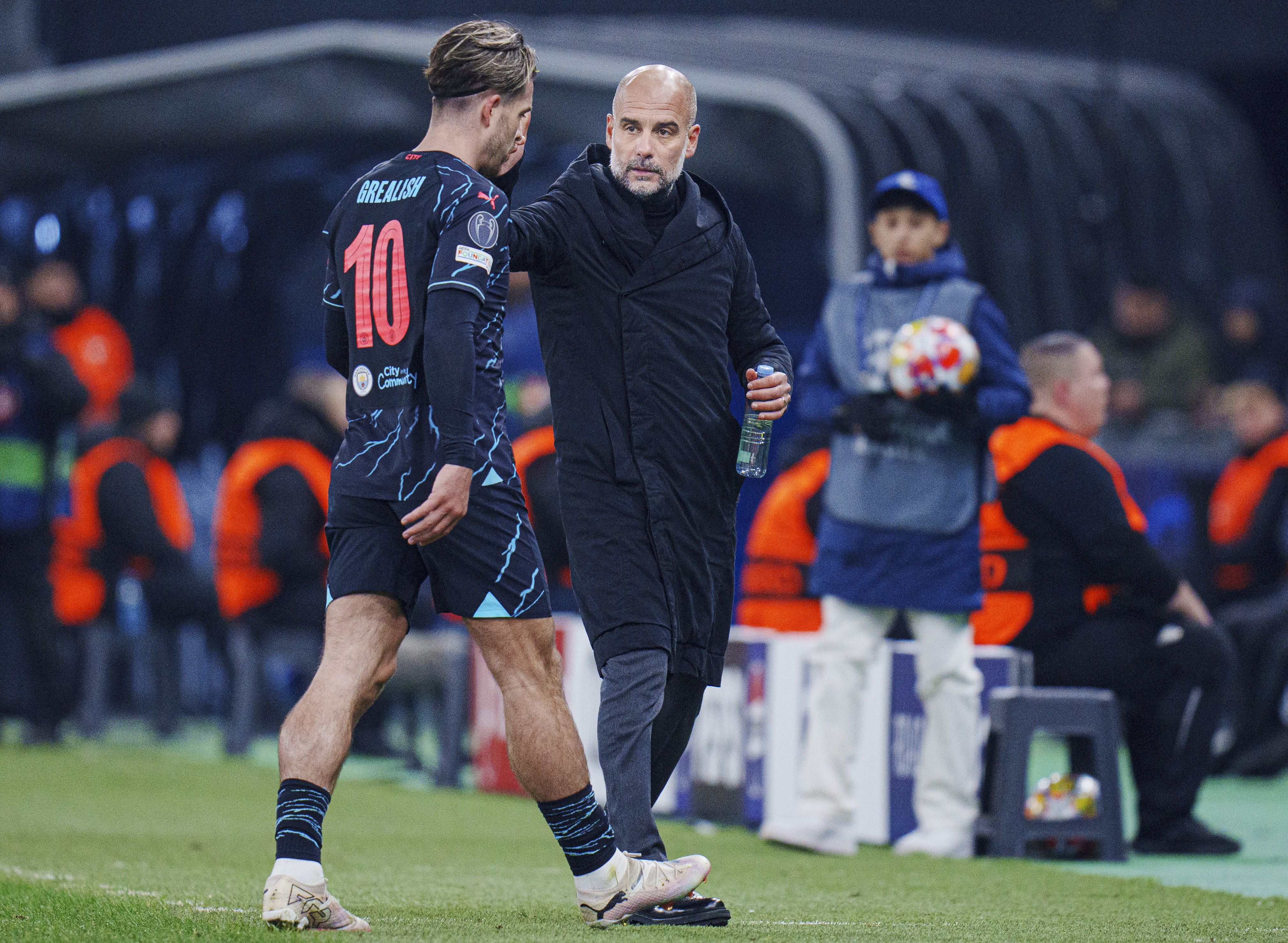 Pep Guardiola greets Jack Grealish, left, as he is substituted against FC Copenhagen