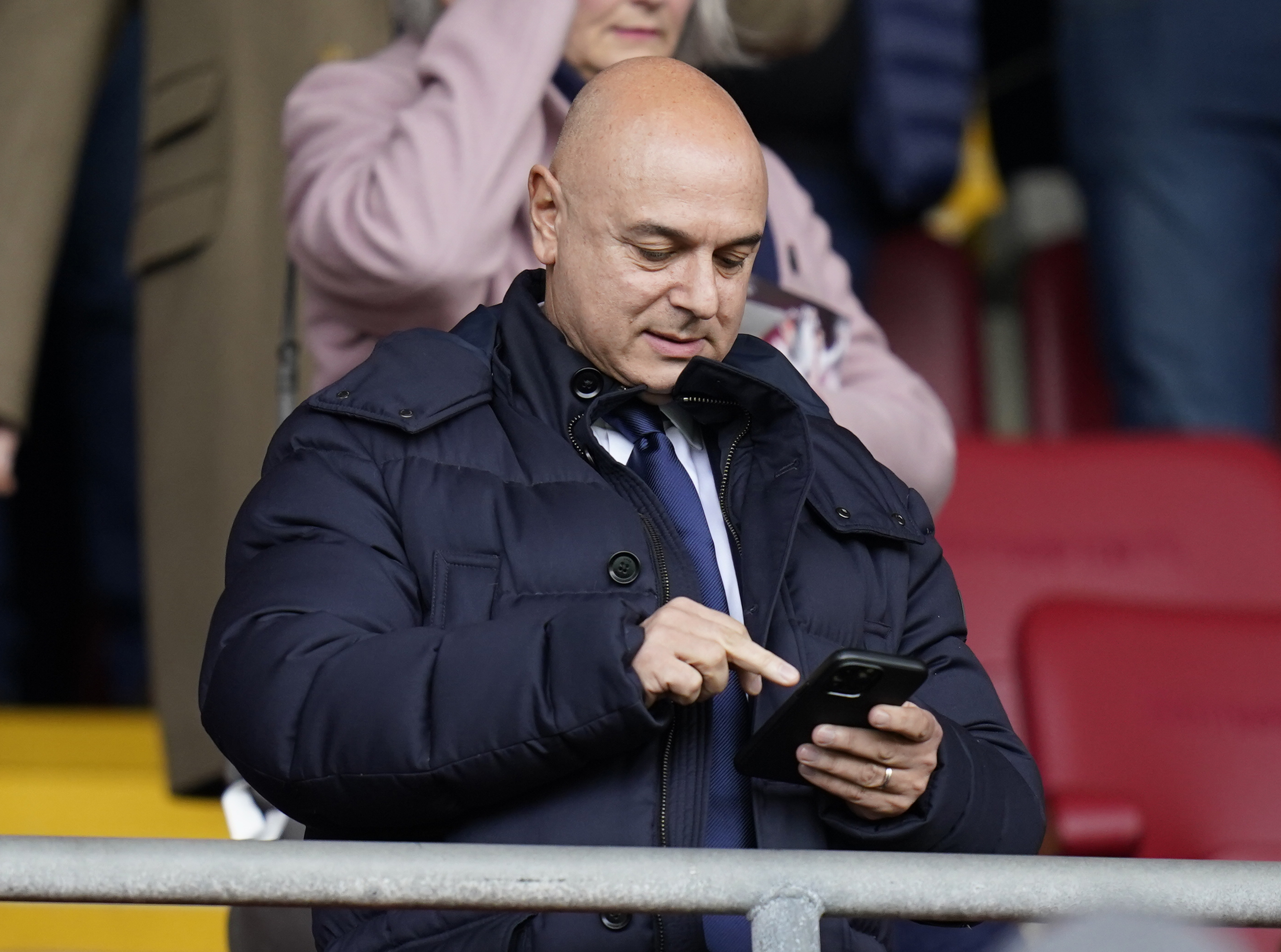 Daniel Levy checks his phone in the Tottenham directors' box