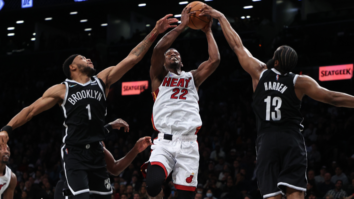 Jimmy Butler #22 of the Miami Heat shoots against Bruce Brown #1 of the Brooklyn Nets and James Harden #13 of the Brooklyn Nets