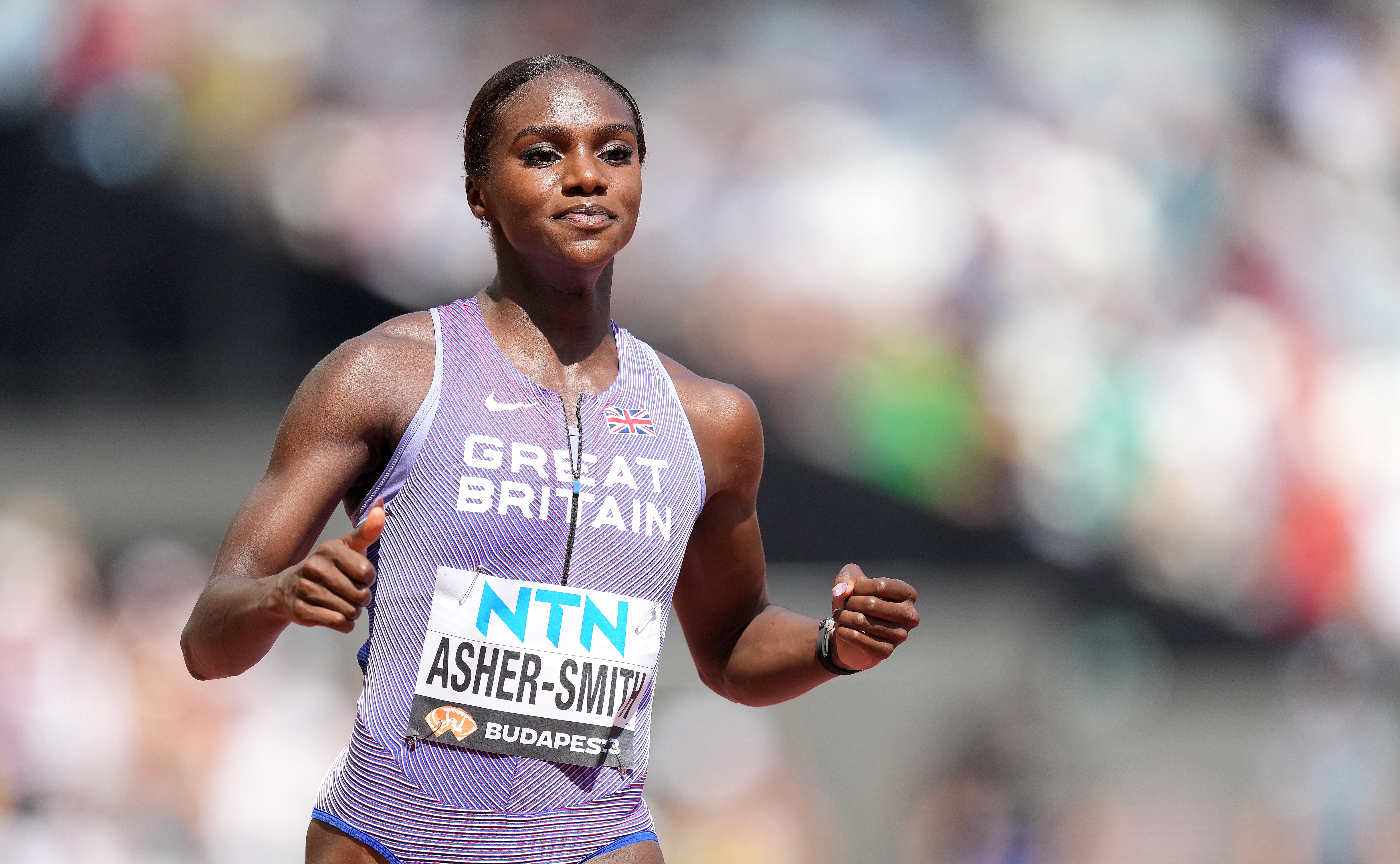 Dina Asher-Smith eased through her heat