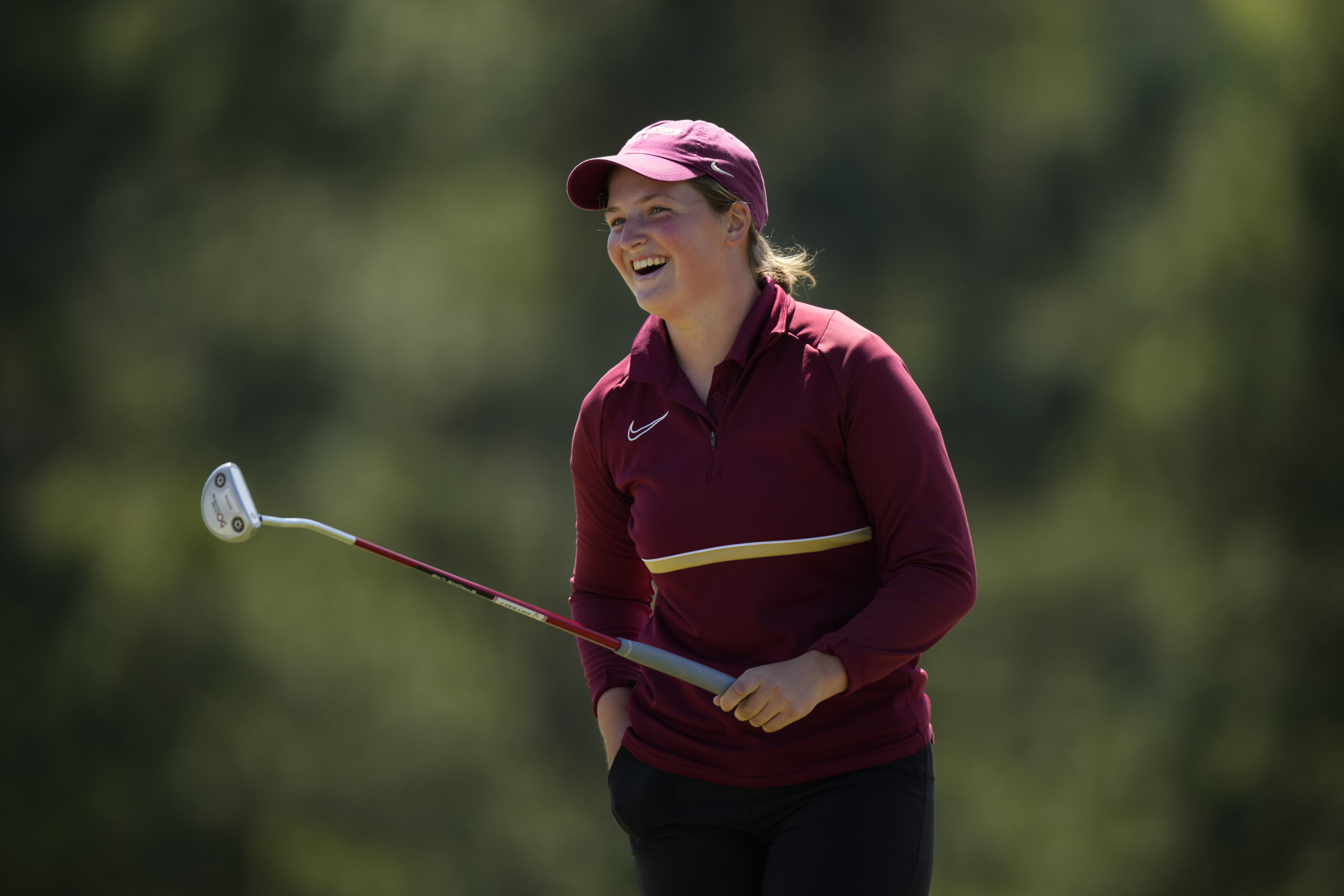 Lottie Woad reacts after holing a birdie putt on the 18th