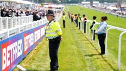A police officer stands by the track during the Derby
