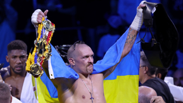 Oleksandr Usyk celebrates after winning the heavyweight boxing rematch for the WBA, WBO, IBO and IBF titles against Anthony Joshua