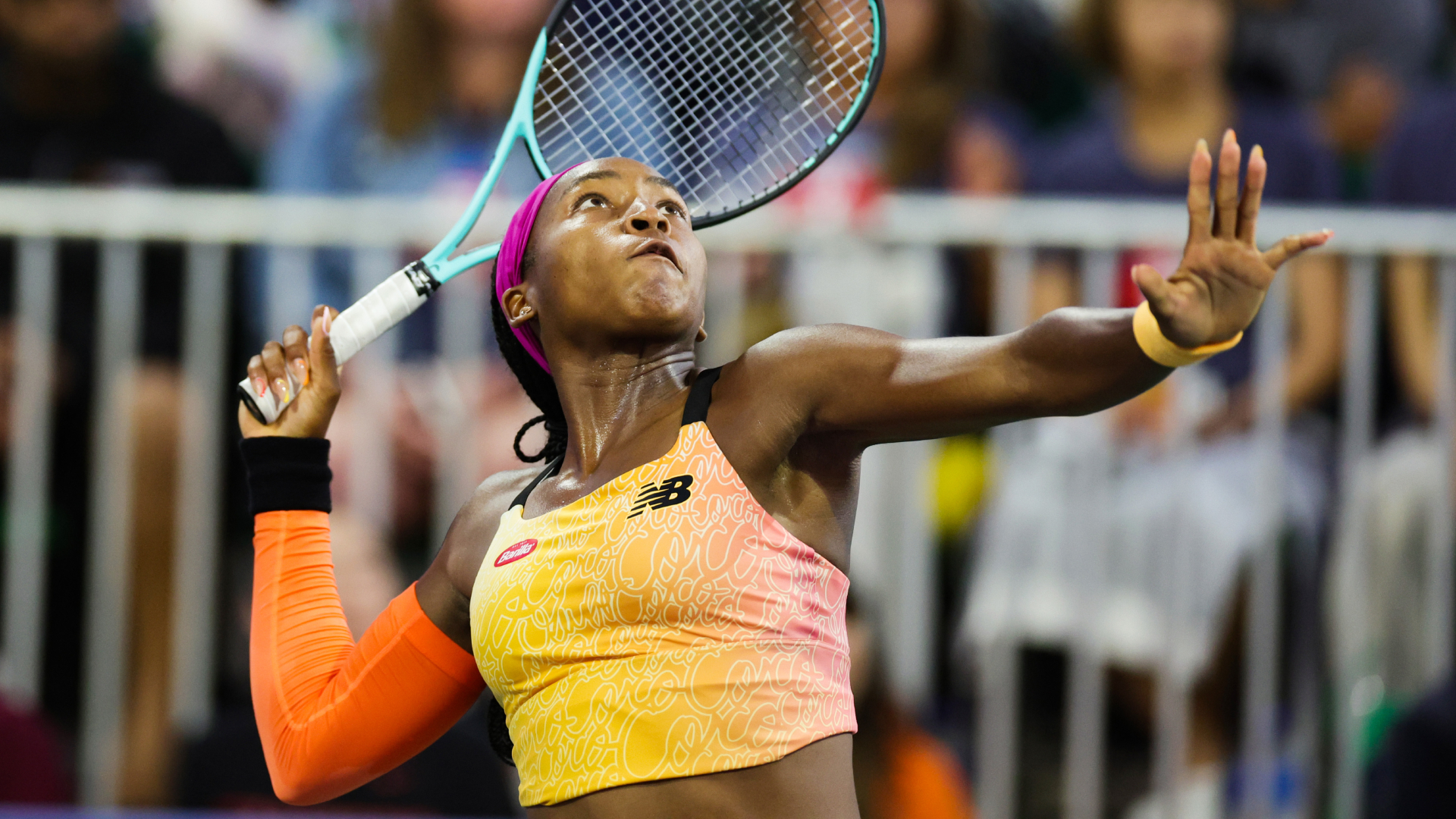 Coco Gauff winds up for a smash against Naomi Osaka