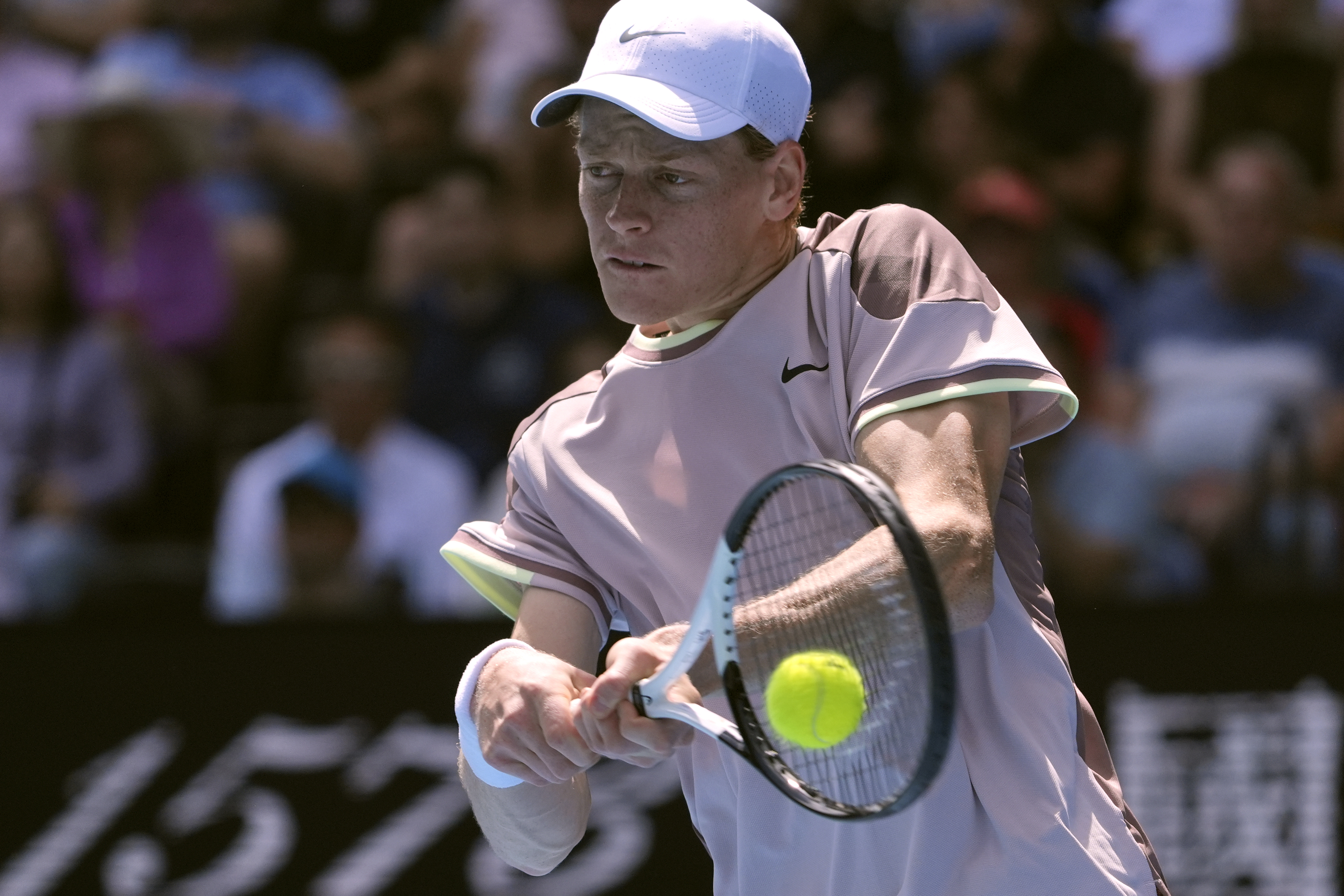 Jannik Sinner hits a backhand