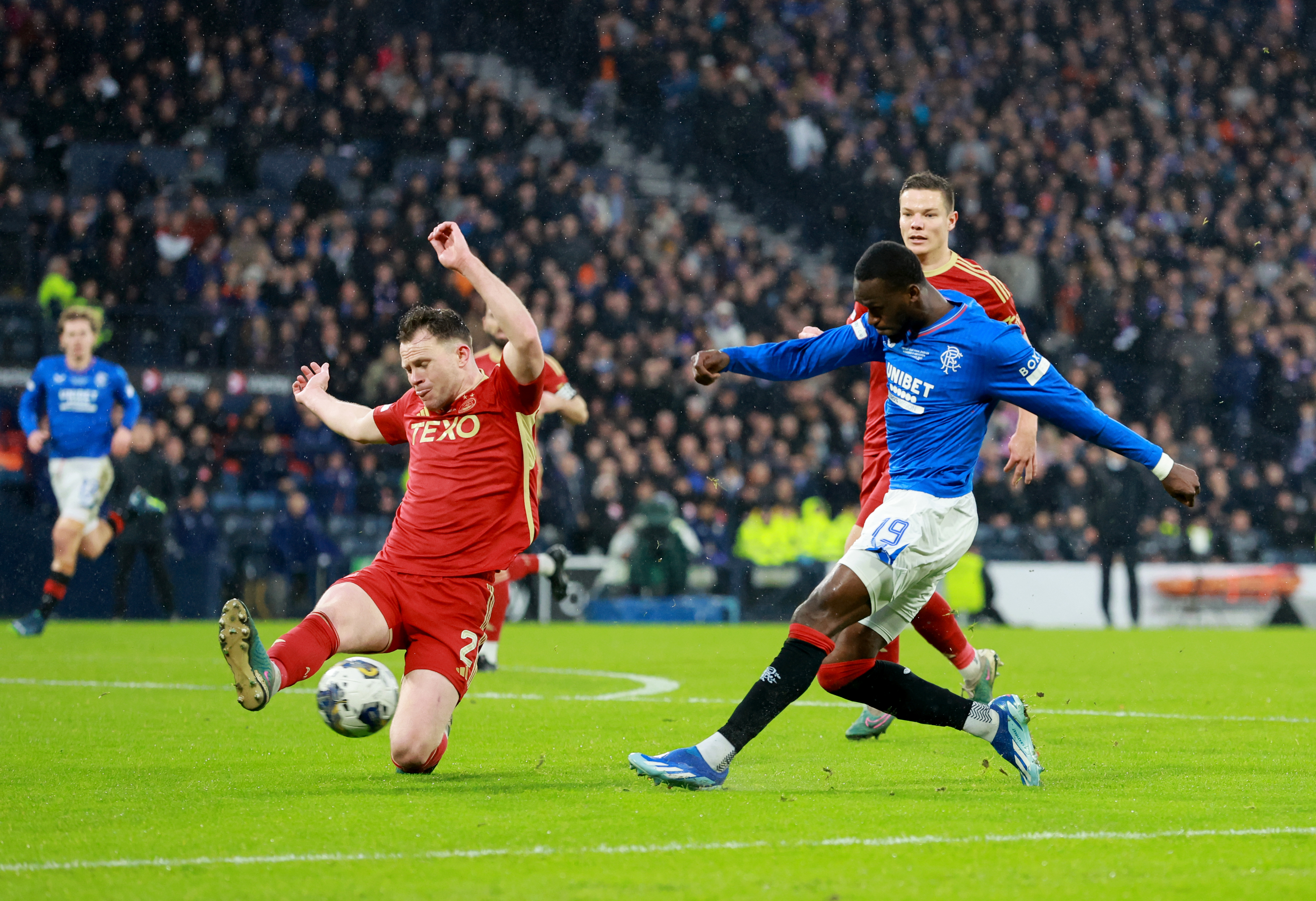 Rangers' Abdallah Sima, right, has a shot on goal charged down by Aberdeen's Nicky Devlin, left, during the Viaplay Cup final
