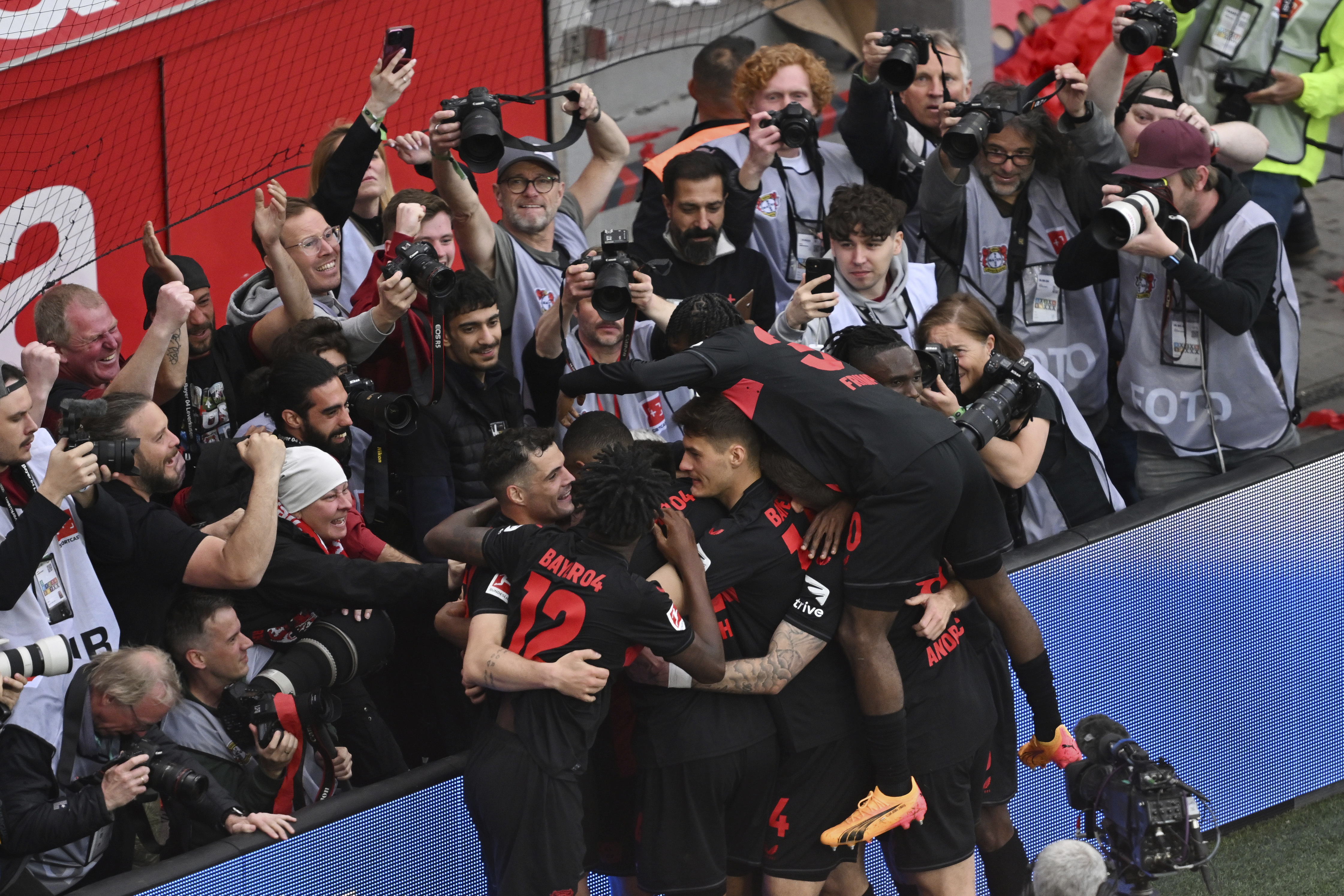 Bayer Leverkusen players celebrate after Florian Wirtz scored their third goal against Werder Bremen