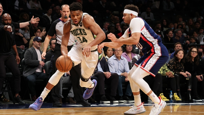 Giannis Antetokounmpo drives to the rim against Seth Curry.