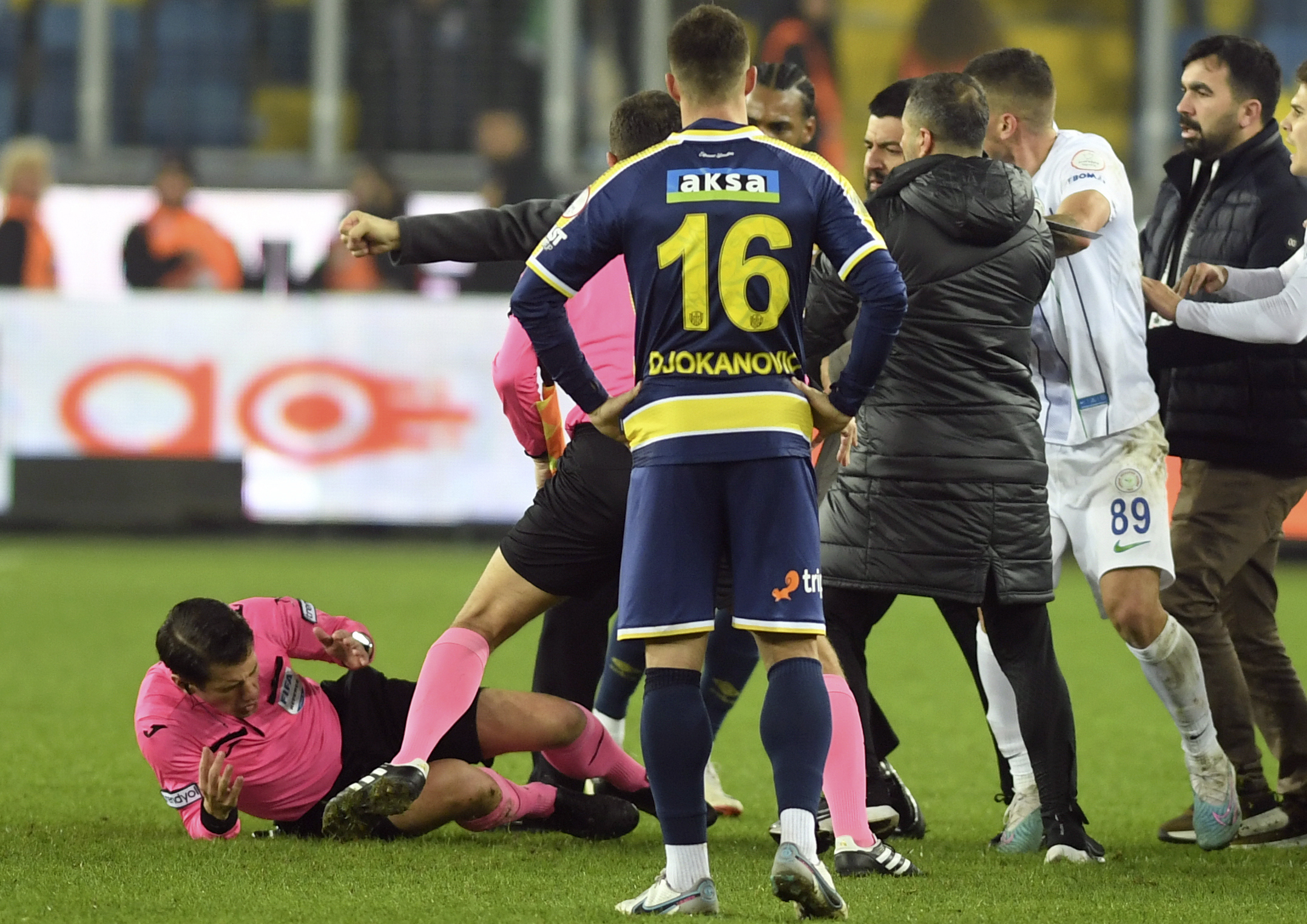 Referee Halil Umut Meler, left, falls down after being punched by Ankaragucu president Faruk Koca