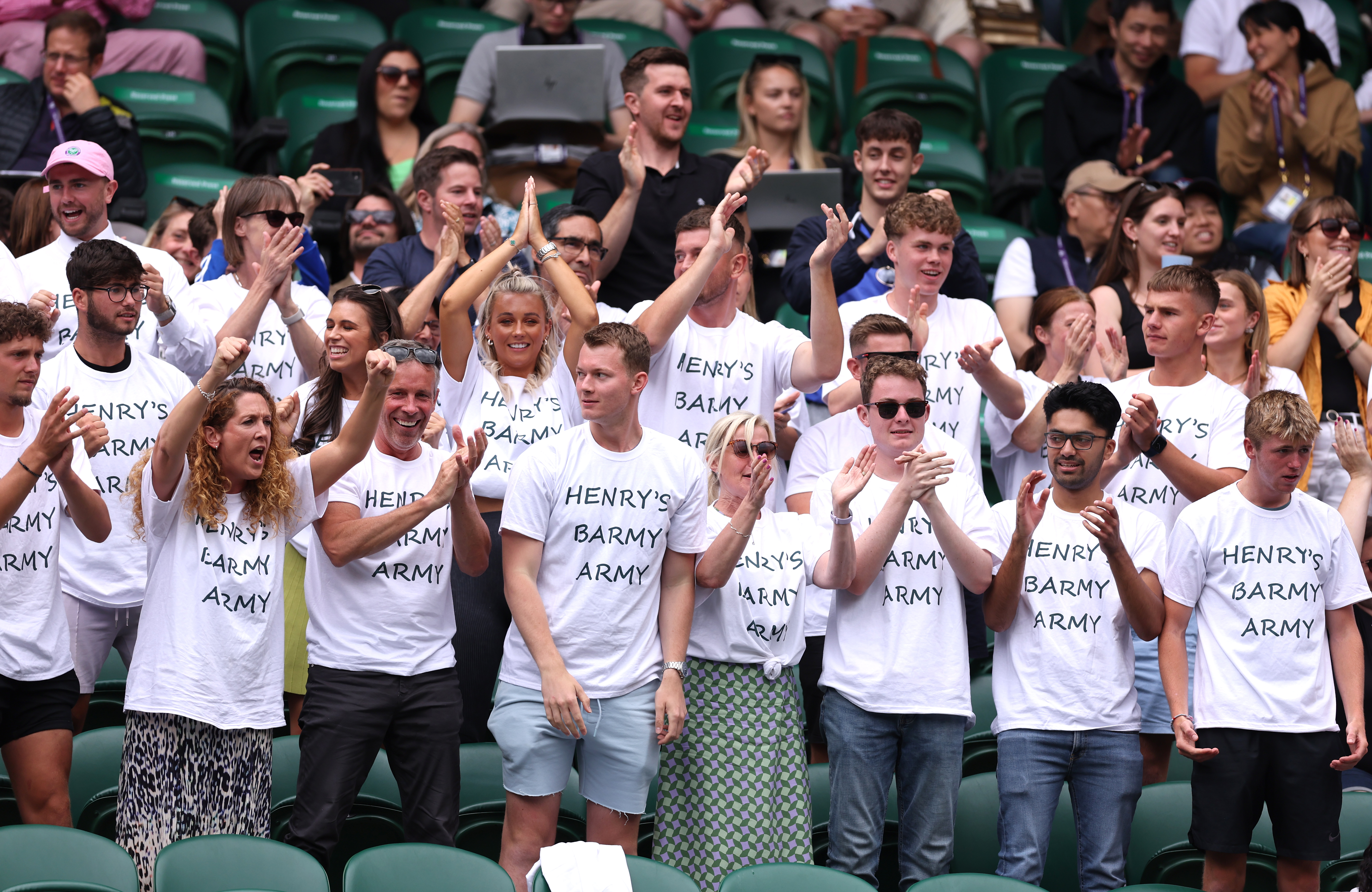 Henry’s Barmy Army cheer Searle on during the boys' singles final