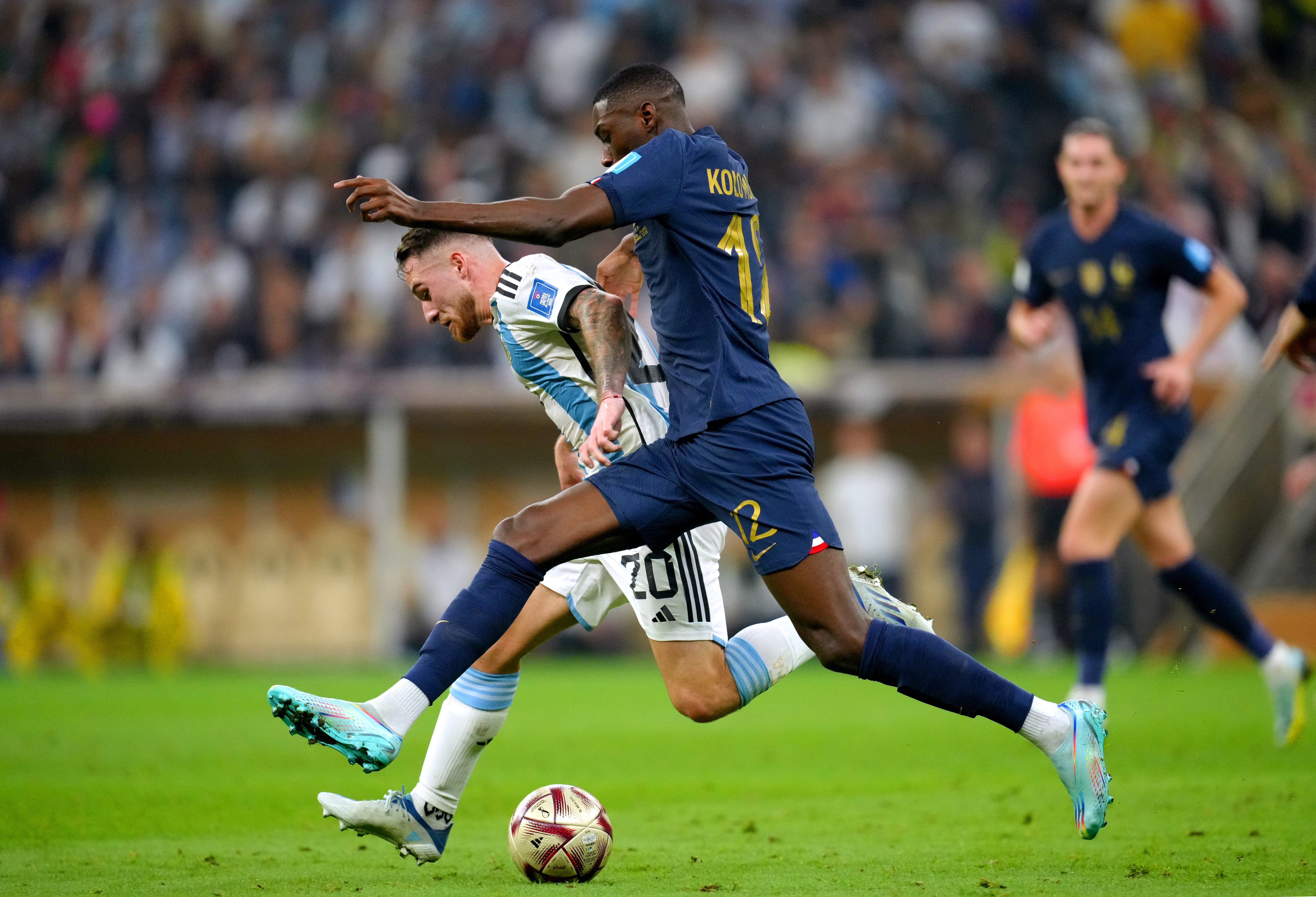 France's Randal Kolo Muani takes on Argentina's Alexis Mac Allister, left