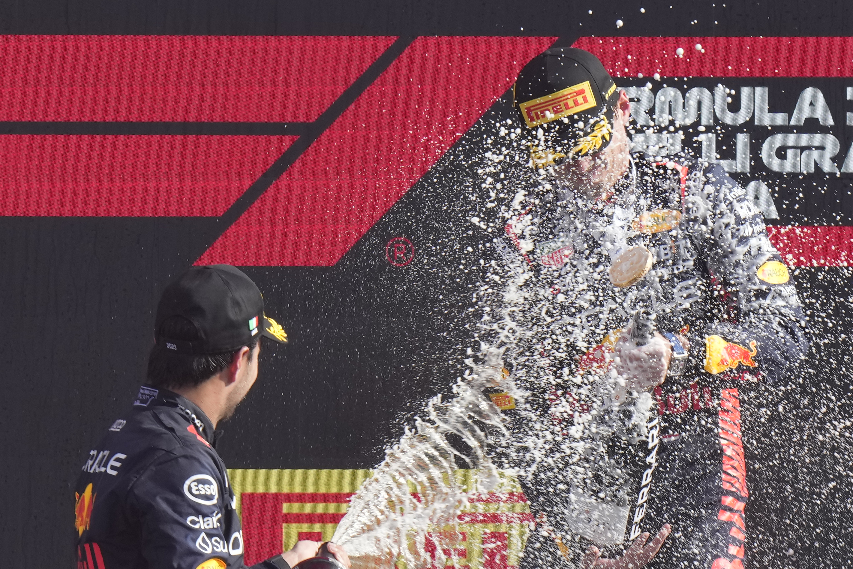 Sergio Perez, left, sprays champagne at Max Verstappen on the Italian Grand Prix podium