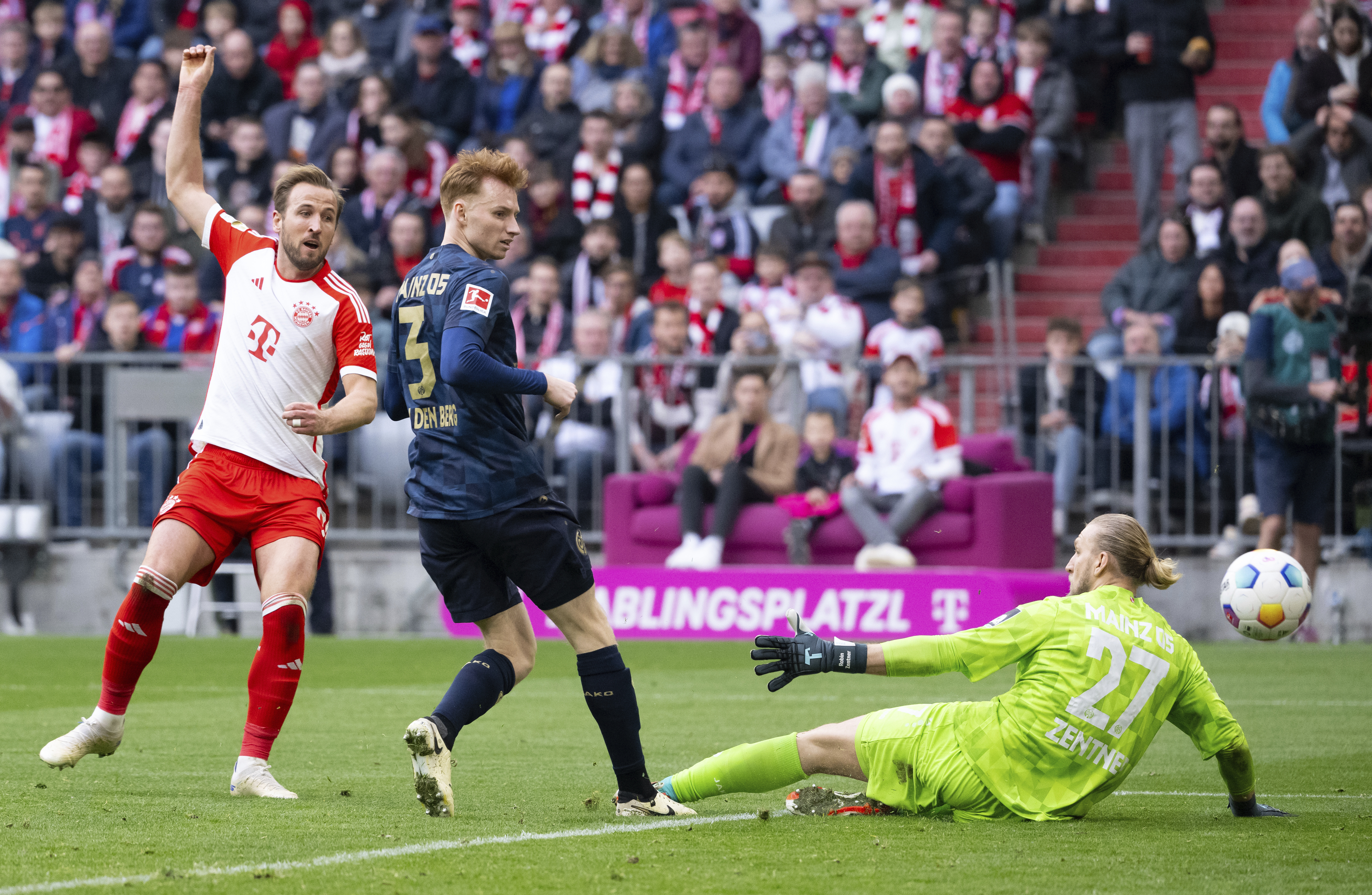 Harry Kane, left, scores his second goal against Mainz