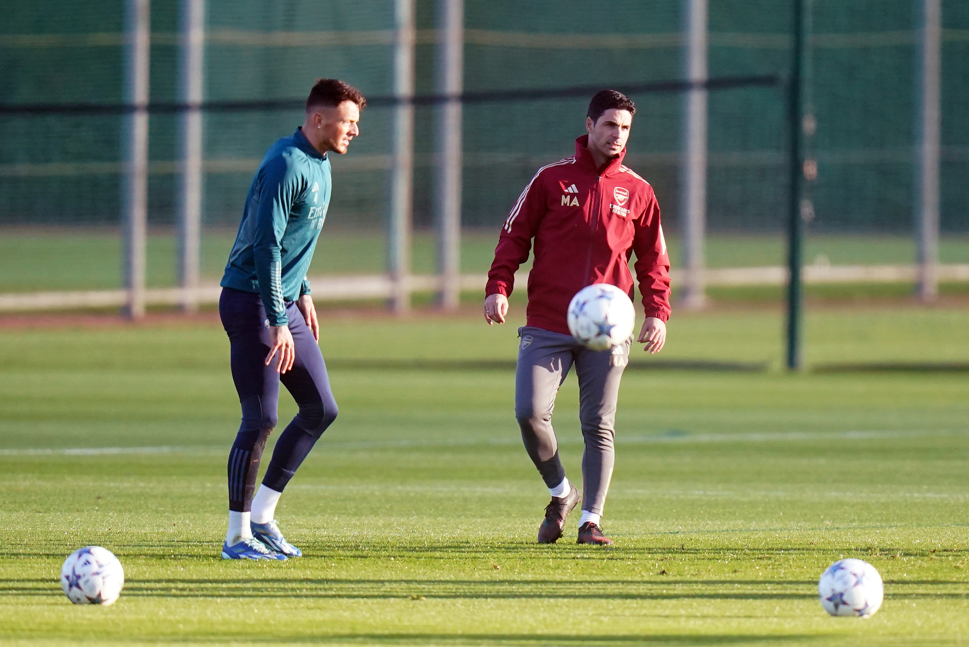 Arsenal manager Mikel Arteta with Ben White (left) during a training session