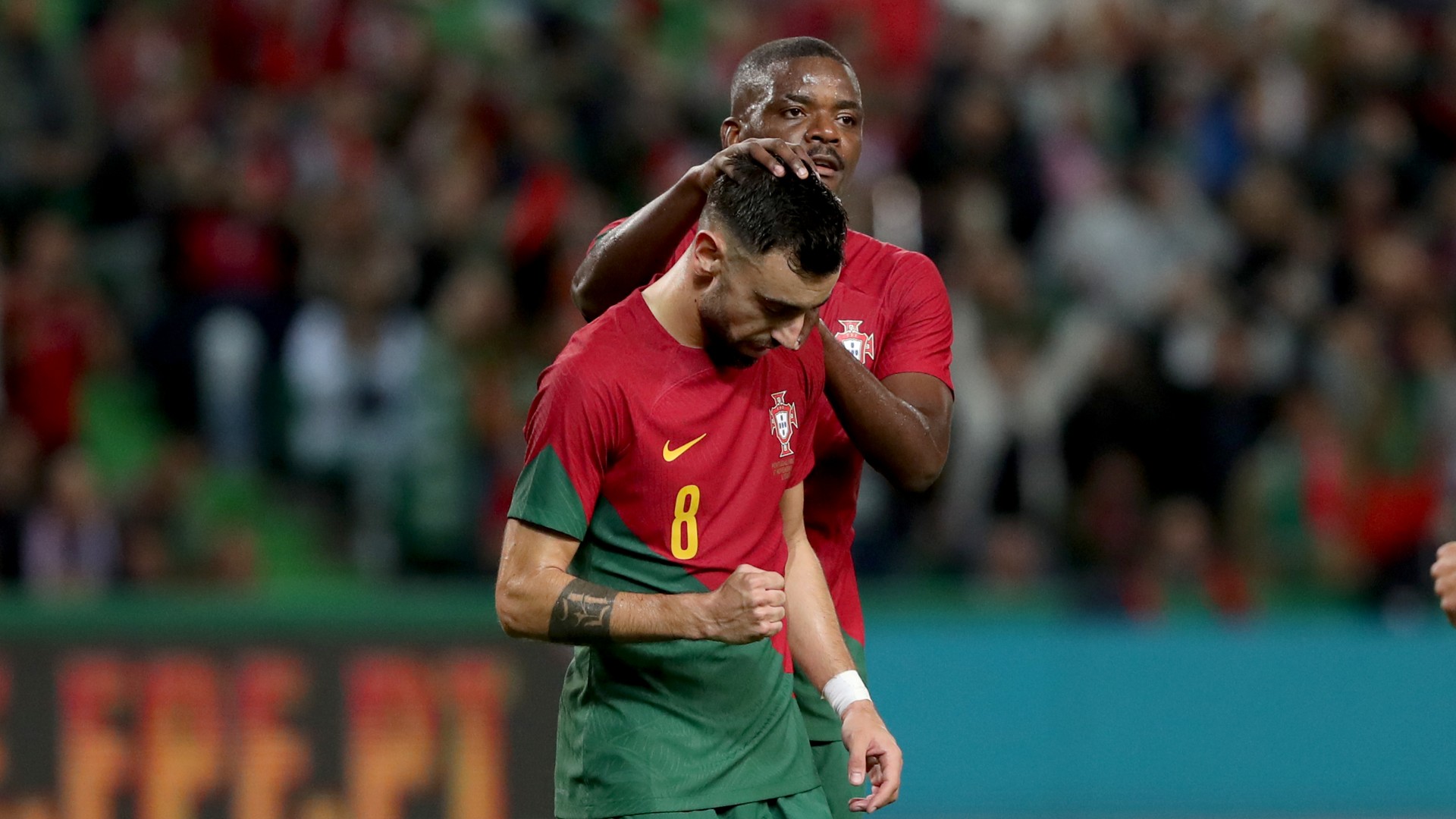 William Carvalho congratulates Portugal's star of the show Bruno Fernandes on Thursday in Lisbon