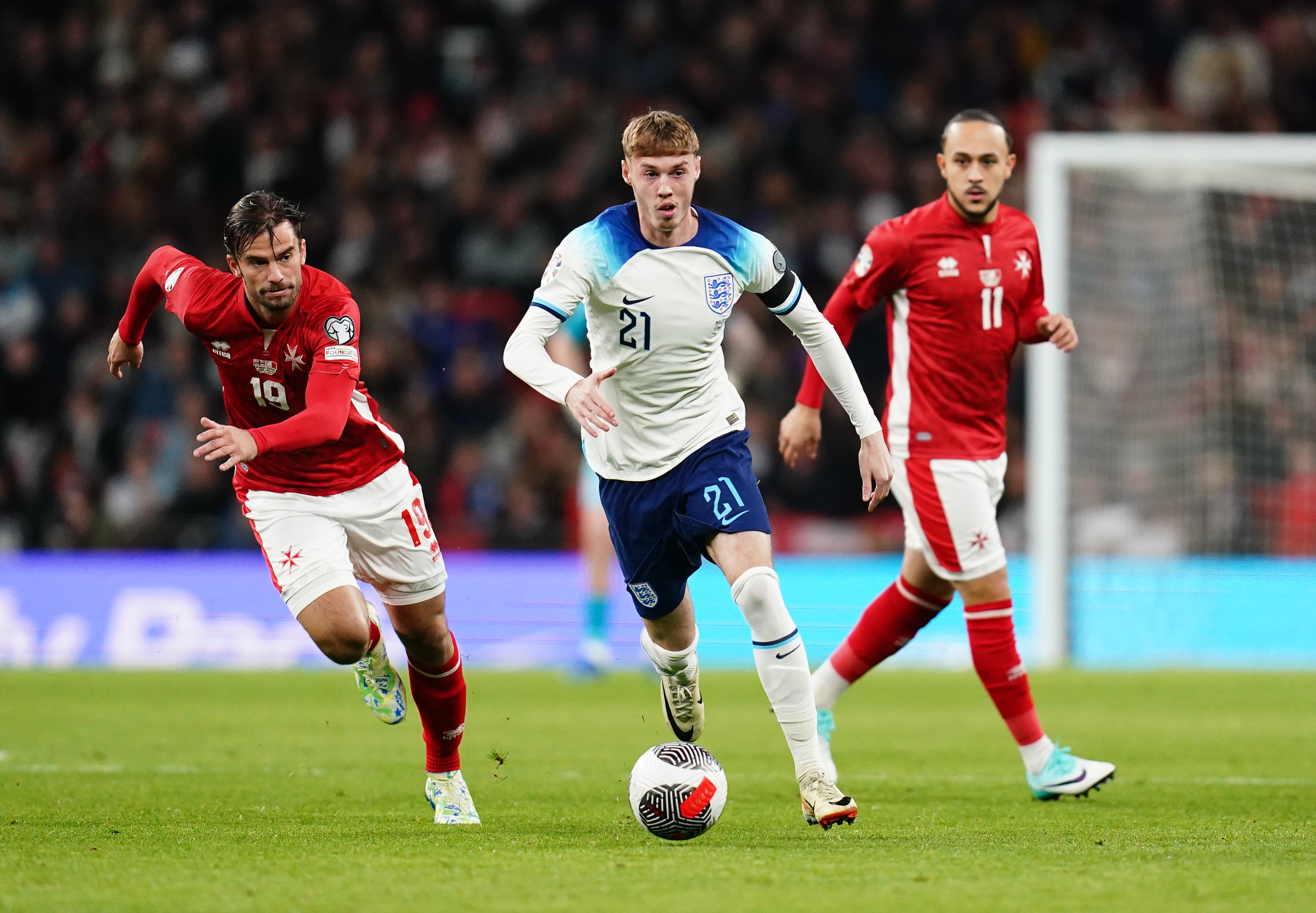 England's Cole Palmer (centre) gets away from Malta’s Bjorn Kristensen