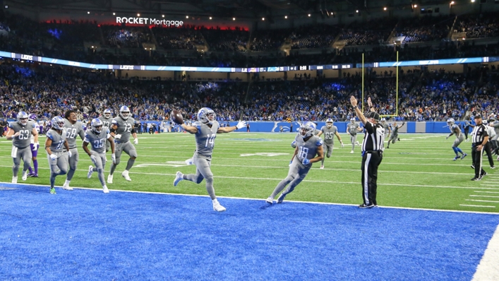 Amon-Ra St. Brown celebrates scoring the Lions' winning touchdown against the Vikings