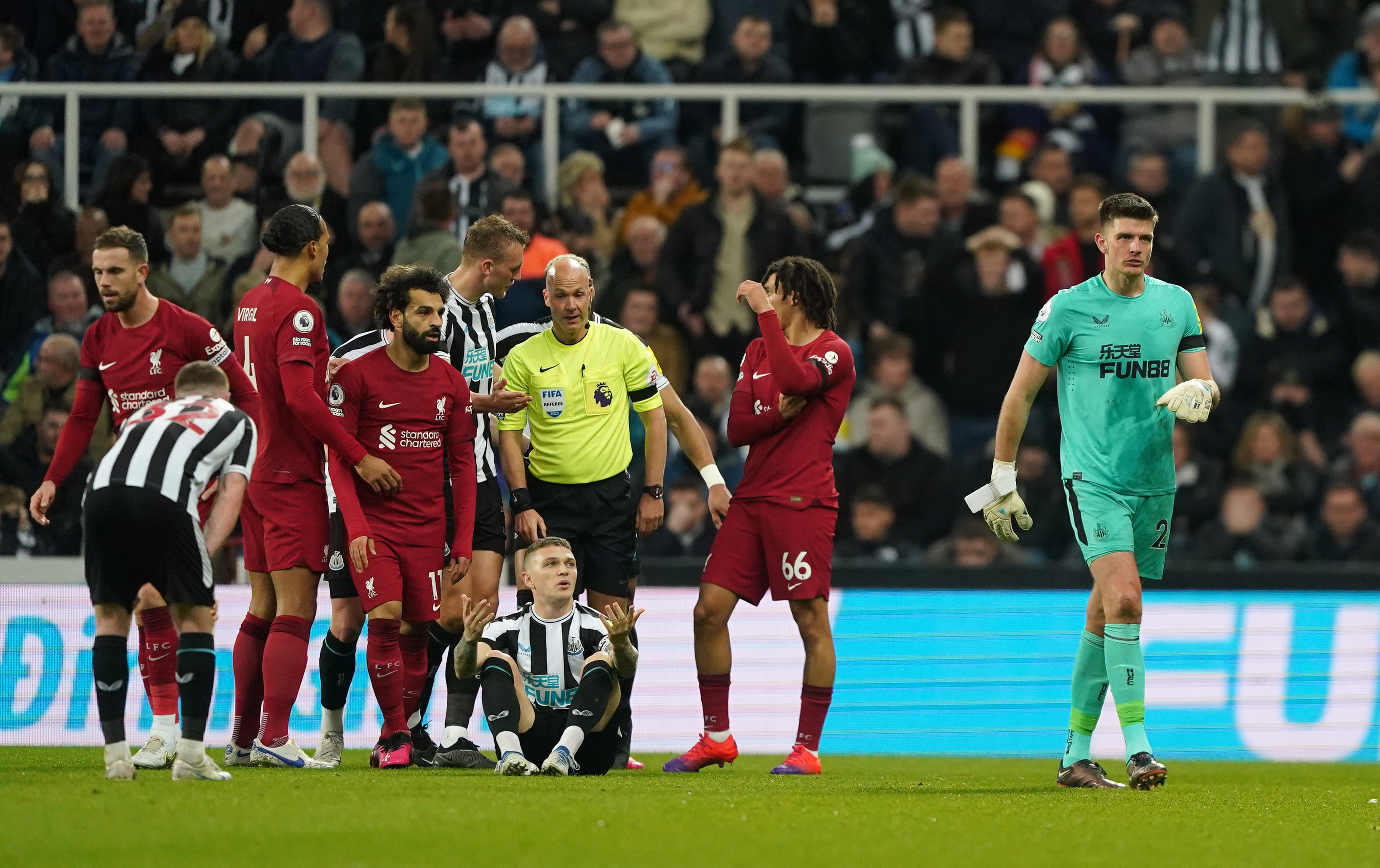 Newcastle keeper Nick Pope (right) leaves the pitch after being being shown a red card against Liverpool