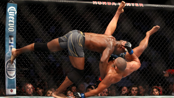 Francis Ngannou of Cameroon tackles Ciryl Gane of France in their heavyweight title fight during the UFC 270 event