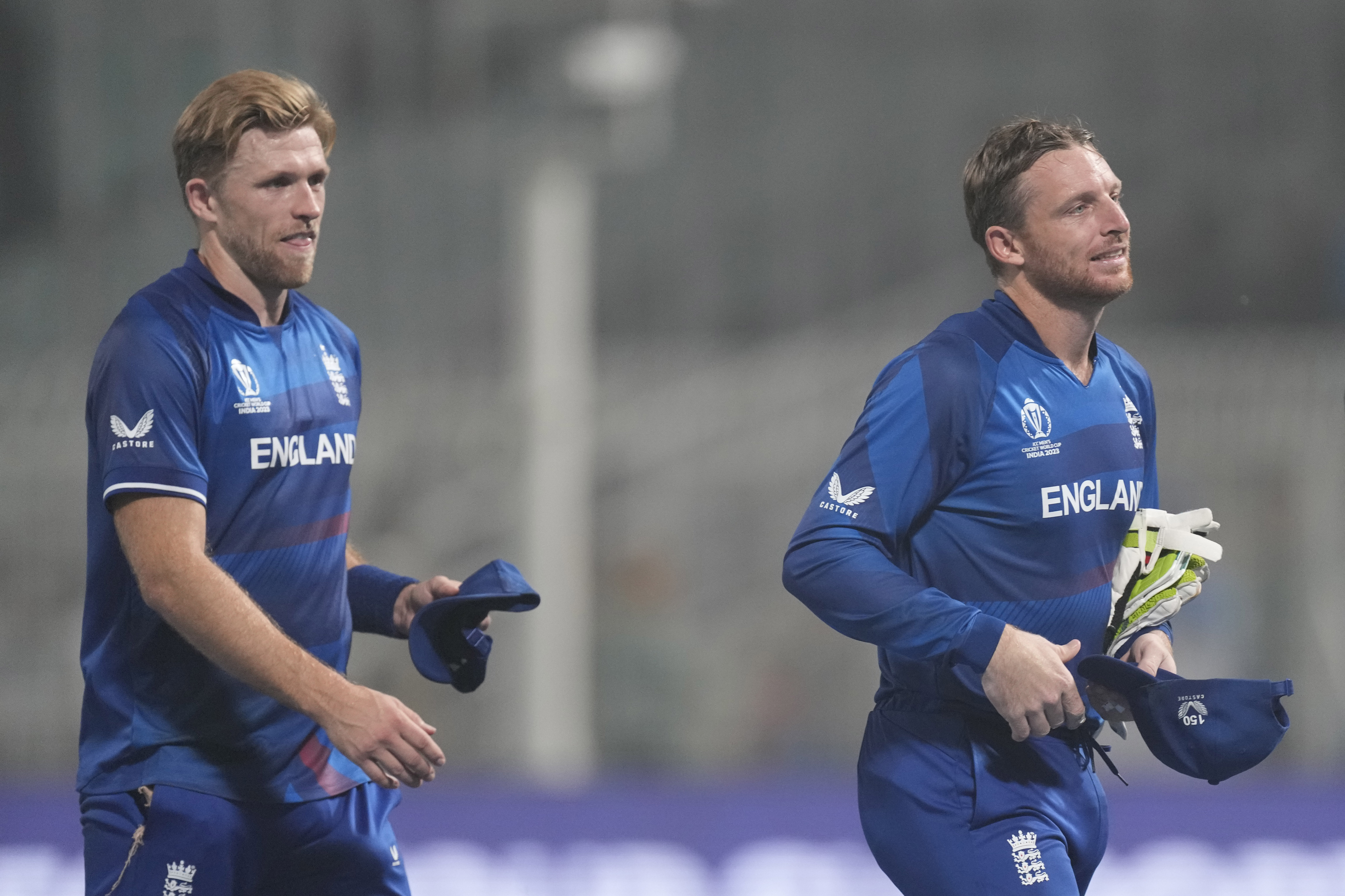 Captain Jos Buttler, right, and David Willey leave the ground after England's World Cup game against Pakistan