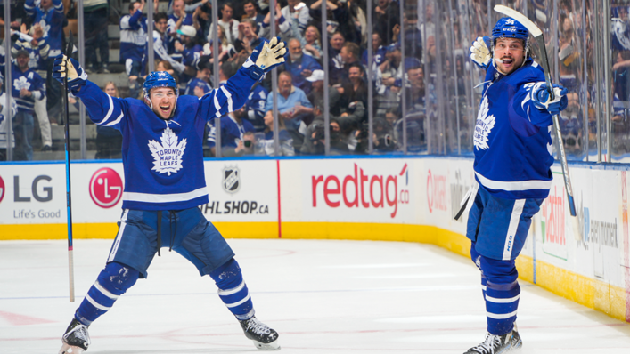 Auston Matthews of the Toronto Maple Leafs celebrates his goal against the Tampa Bay Lightning with teammate Michael Bunting