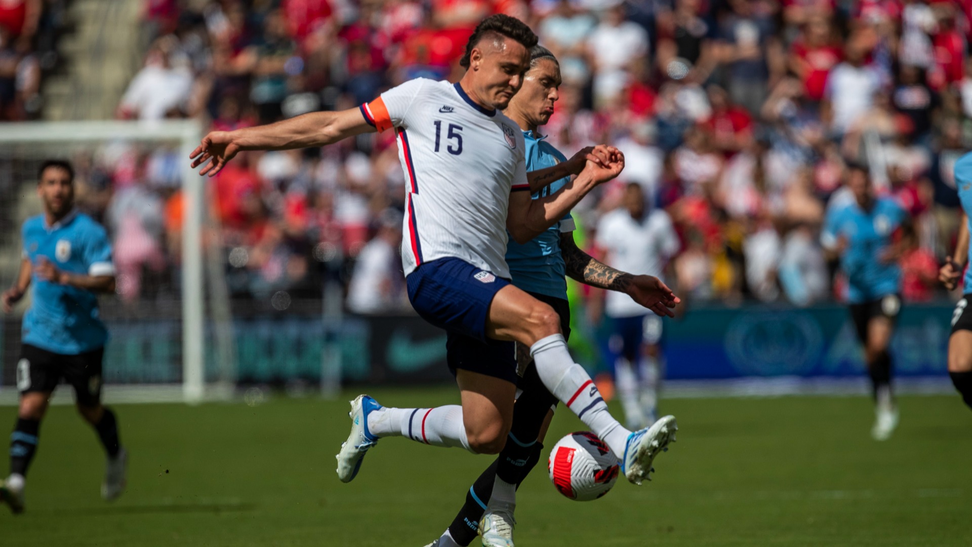 United States defender Aaron Long (left) does battle with Uruguay's Darwin Nunez
