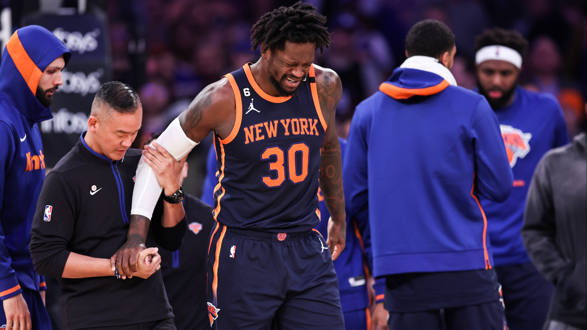 Julius Randle being helped off the court after injuring his ankle