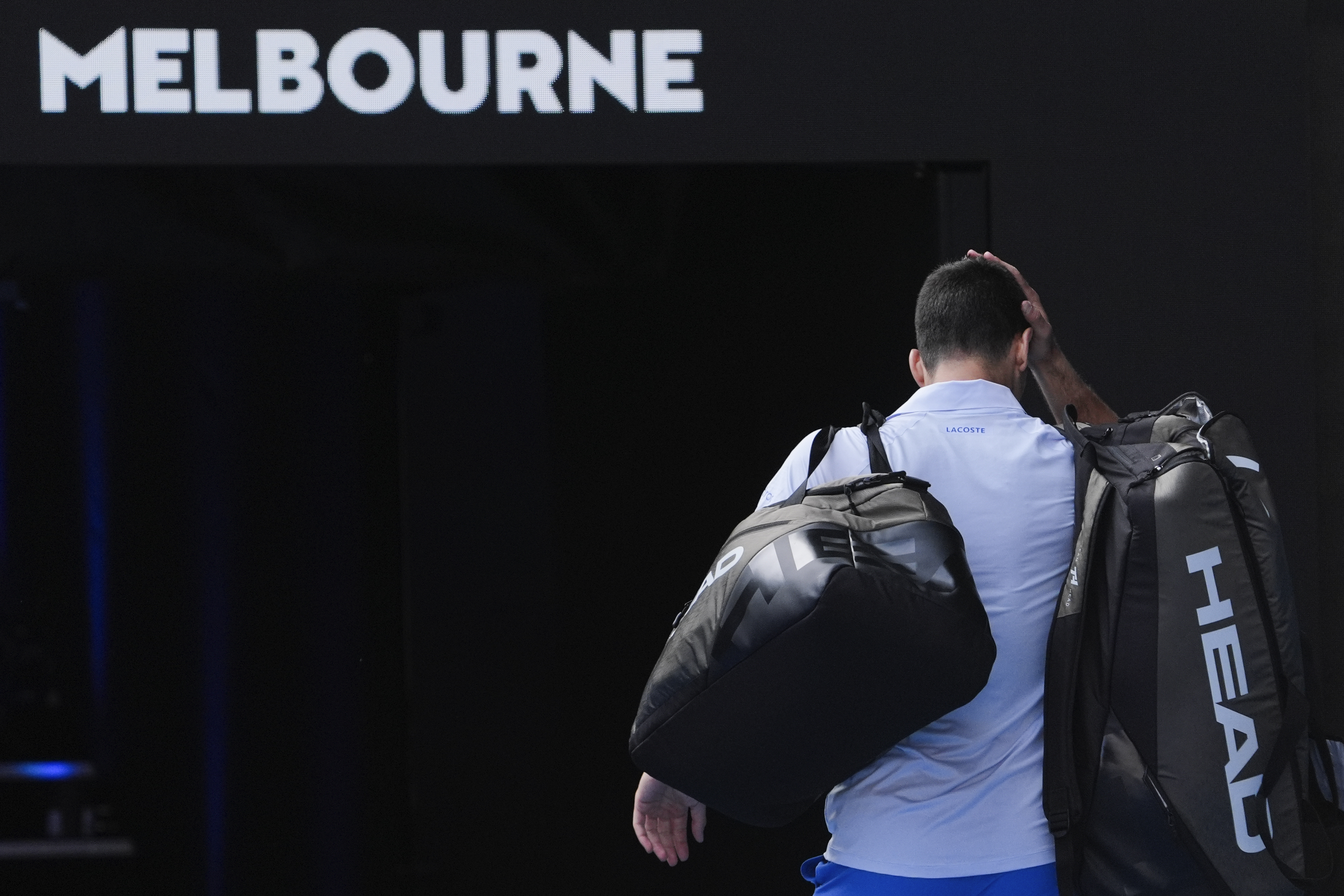Novak Djokovic walks off Rod Laver Arena