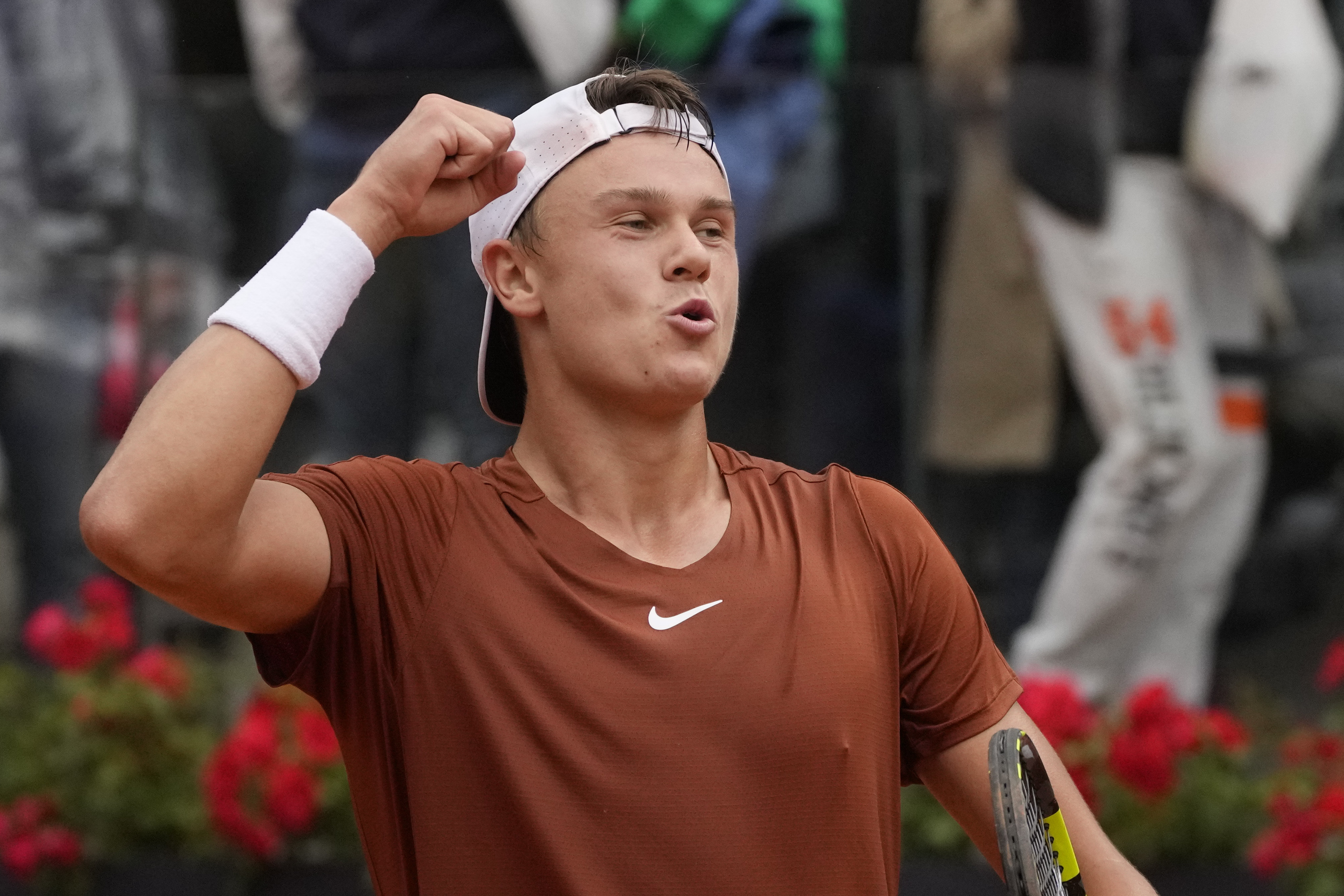 Holger Rune celebrates beating Novak Djokovic in Rome
