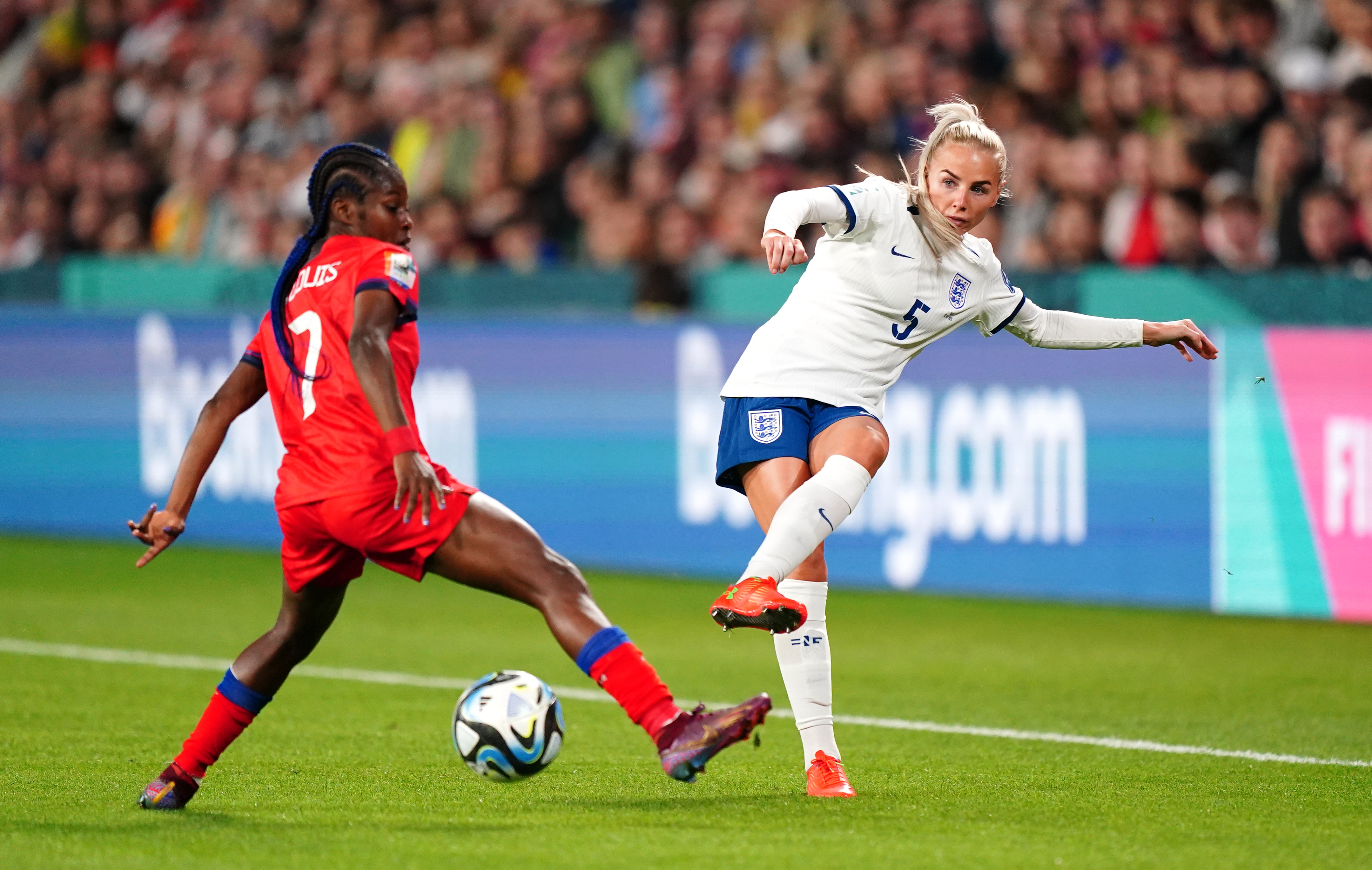 Alex Greenwood, right, passes the ball against Haiti