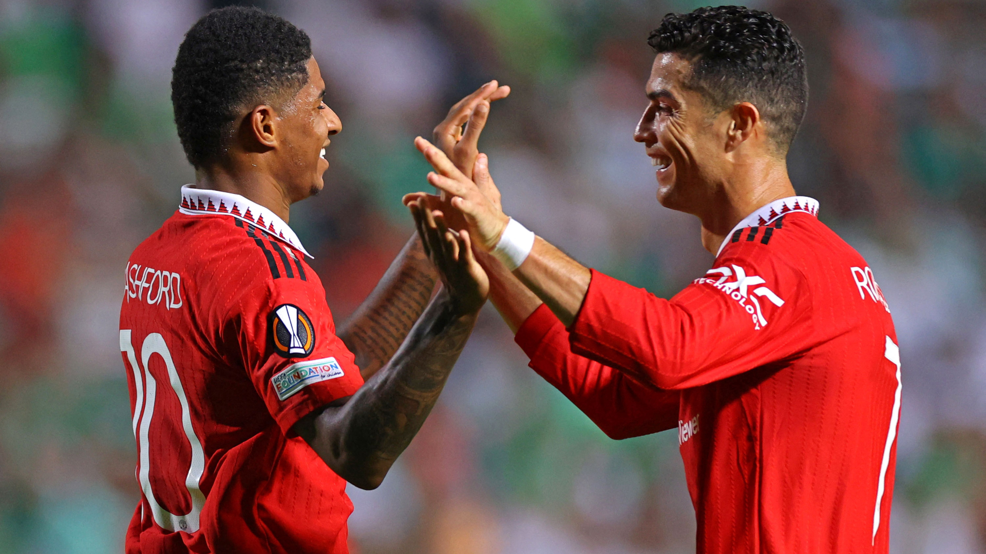 Marcus Rashford celebrates with Cristiano Ronaldo after scoring his second goal
