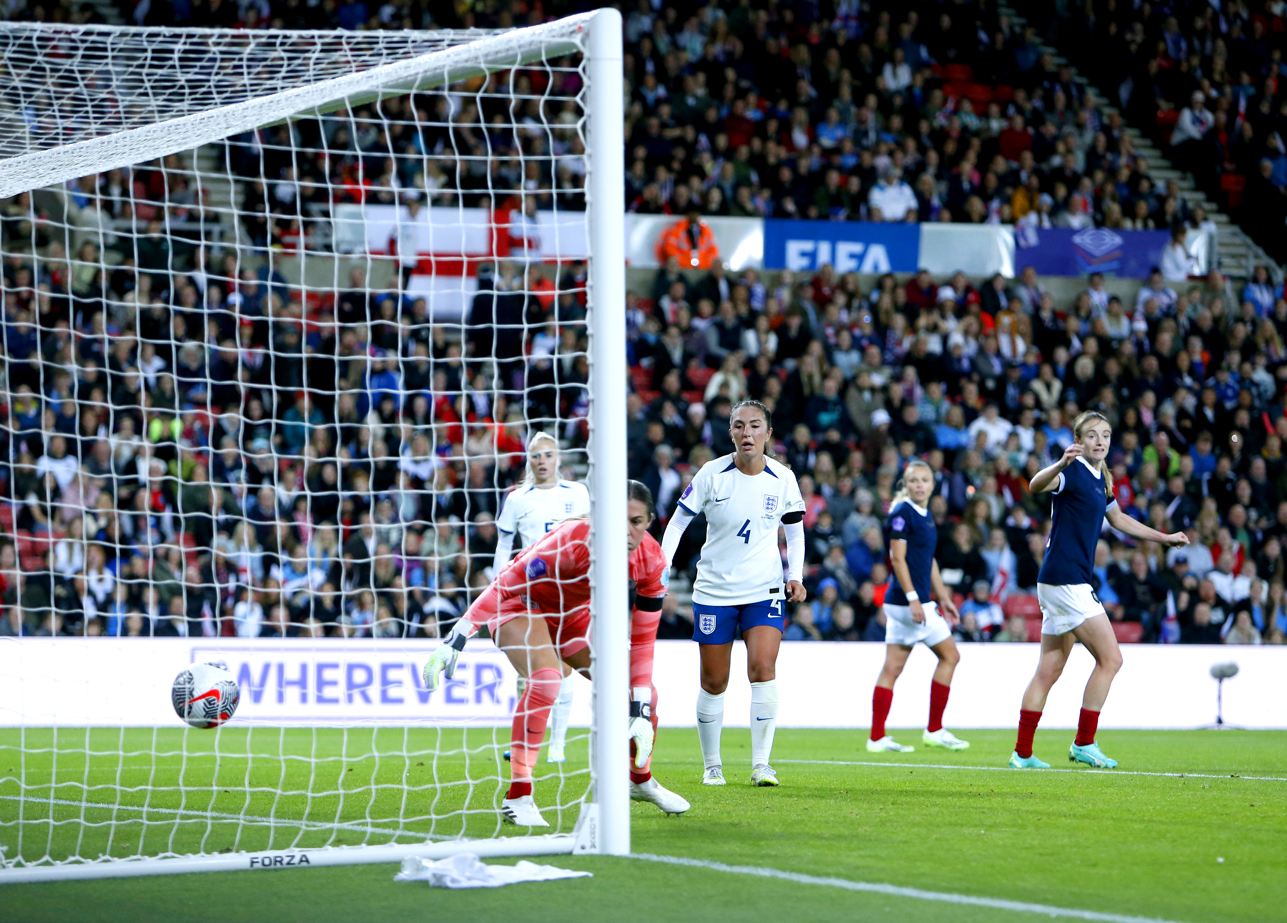 England goalkeeper Mary Earps, centre, is beaten by Kirsty Hanson, not pictured