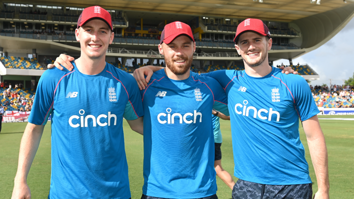 Harry Brook, Phil Salt and George Garton of England pose for a photo after being presented with their caps ahead of the T20 International Series Third T20I match between the West Indies