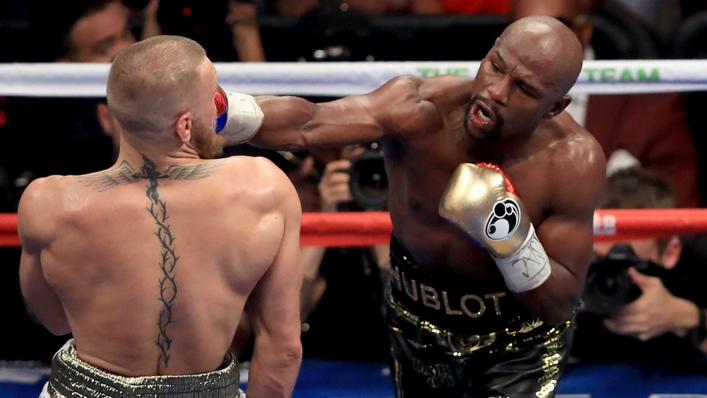 Floyd Mayweather (right) in the ring with Conor McGregor